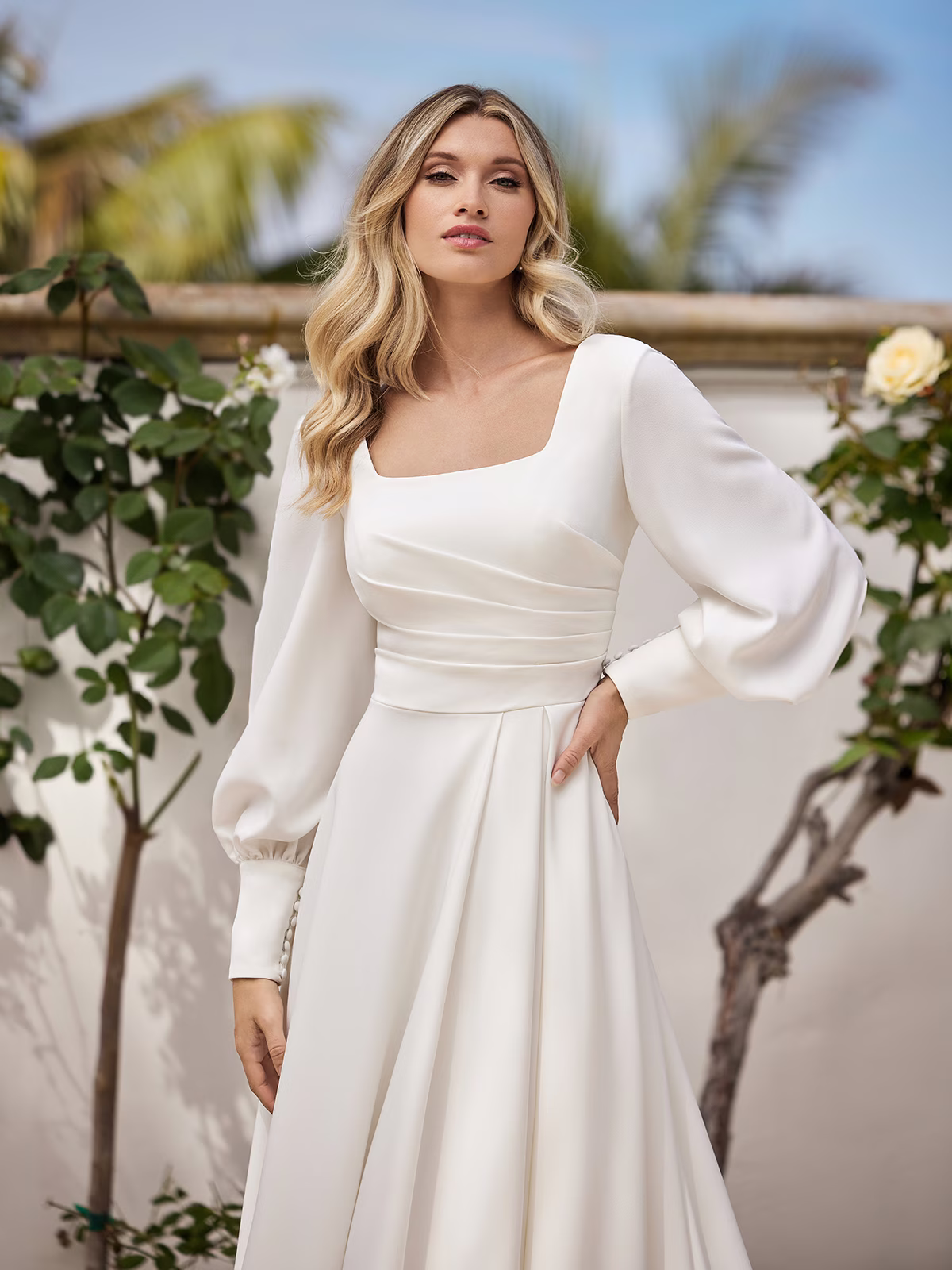 Bride wearing a modest wedding gown with bishop long sleeves