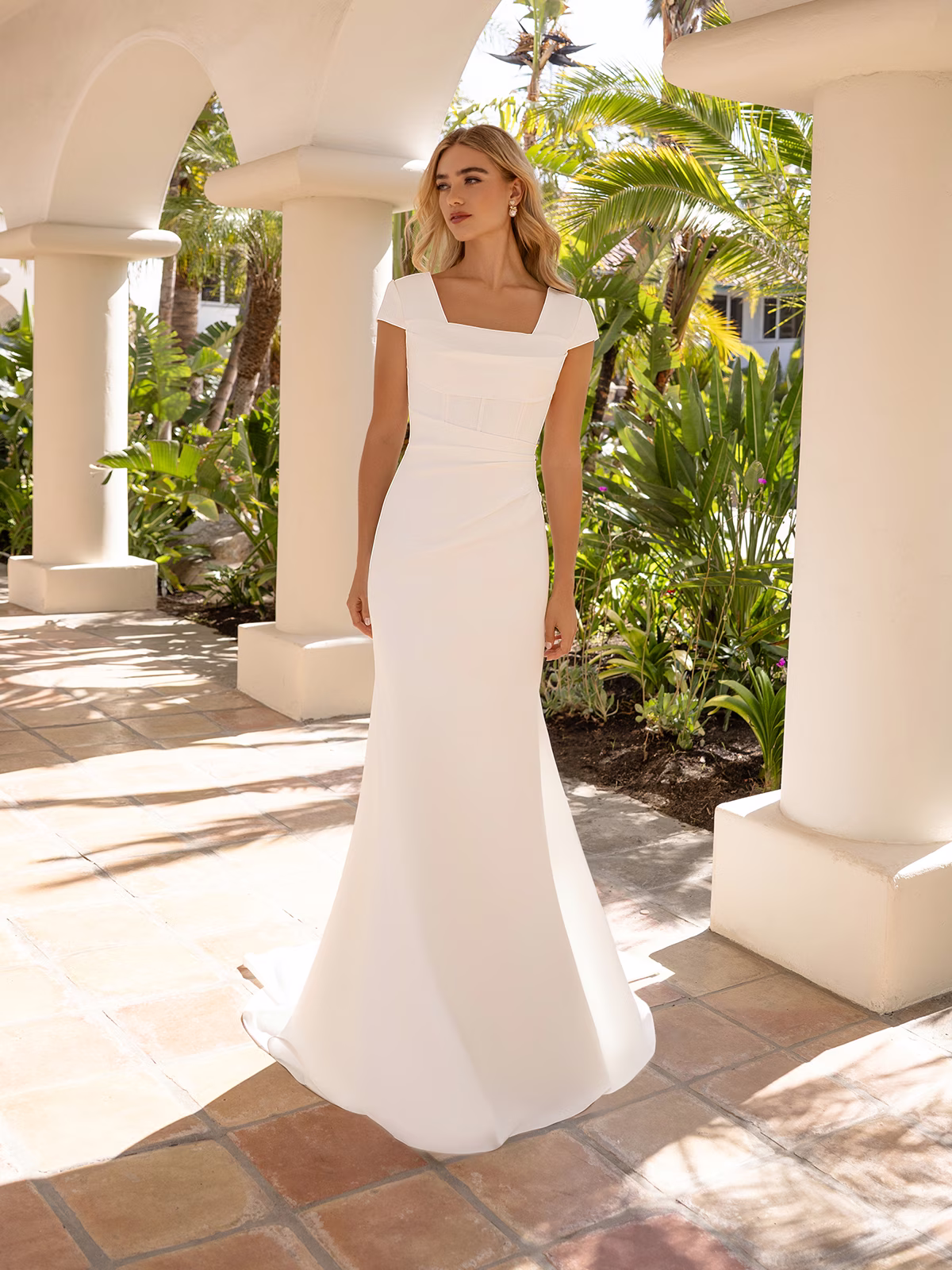 Bride wearing a simple modest crepe wedding dress with short sleeves